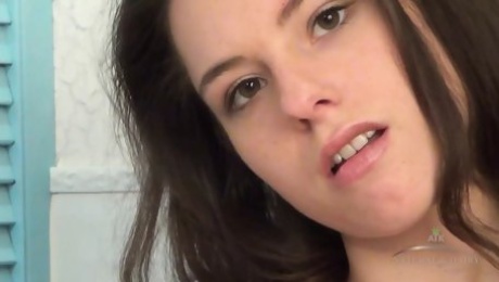 Solo brunette cutie Canella fingers her beautiful hairy pussy and plays with her puffy nipples